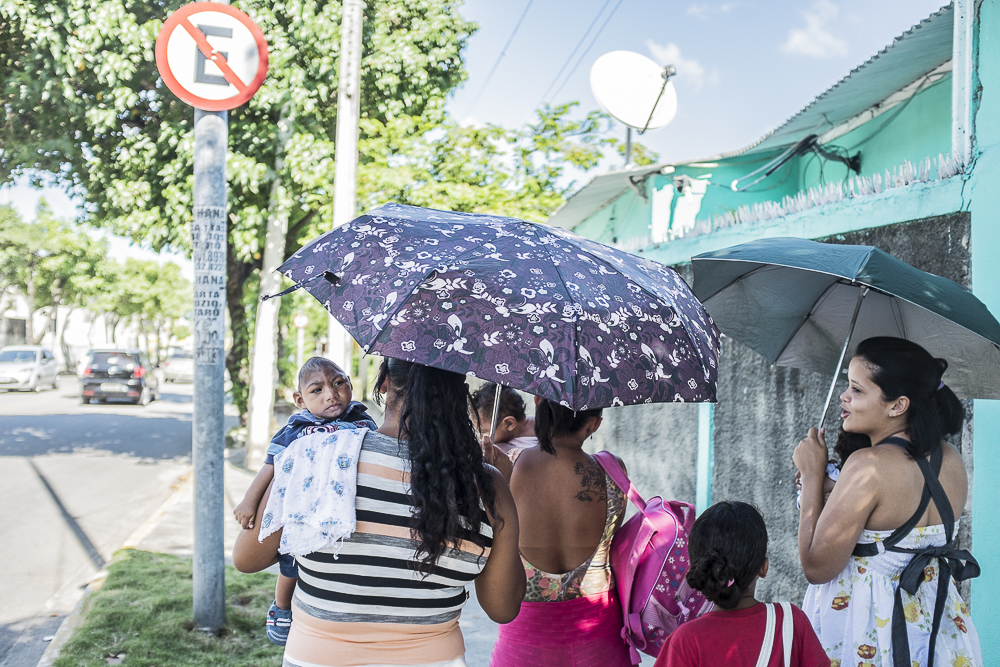A group of mothers with their infants with microcephaly walking