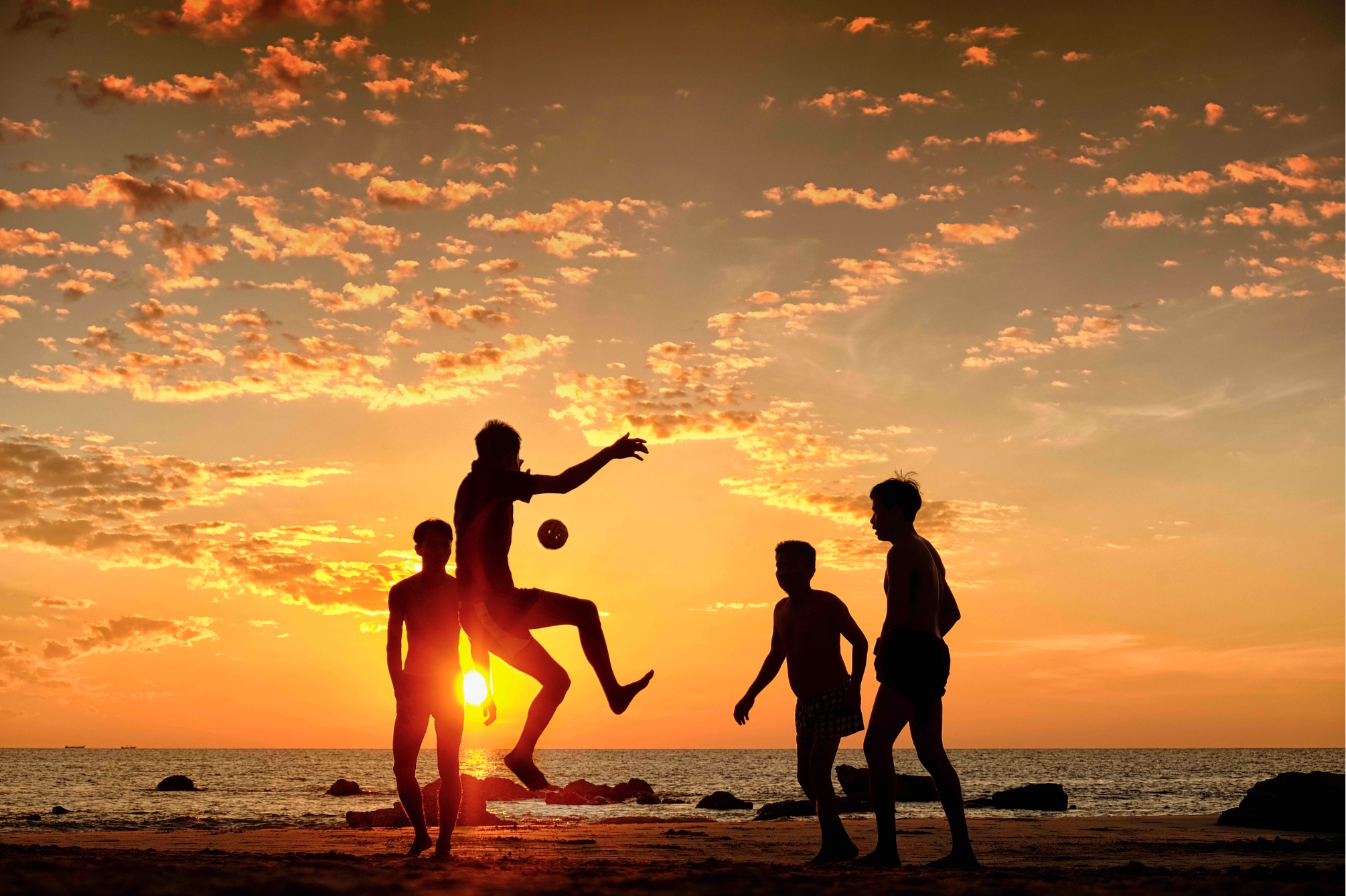 Photo by Andrew Hone. The image was taken at sunset on Ngapali beach in Myanmar, what struck me at the time was how you can go to places you might think are remote, but you will always find people who love sport.  From, the heights of world football in Europe to a beach in Asia, everyone can find the same joy in the game, all you need is ball! These boys certainly have one of the more beautiful backdrops in which to play and ended ended up competing with each other for the best trick with the ball as I lay in the sand shooting away.