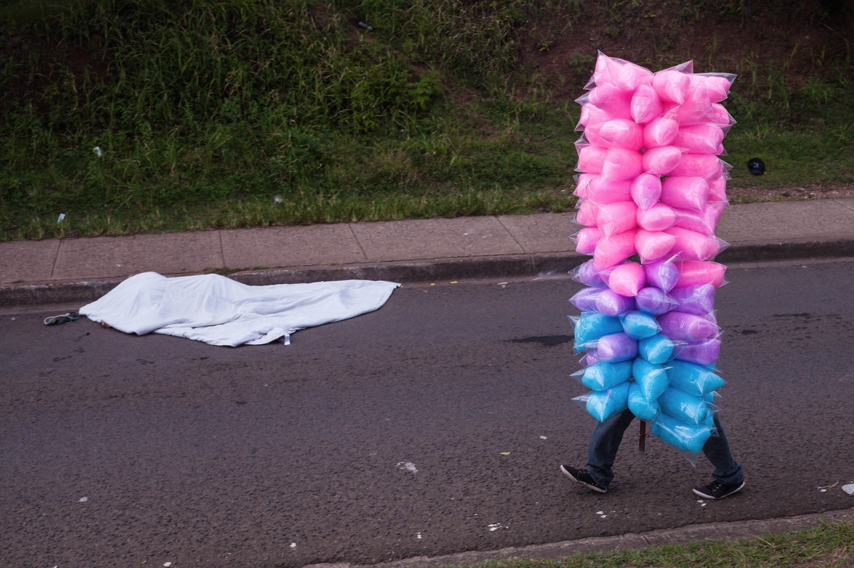 The body of mormon missionary, Jonothan Ordonez, 27, lay covered with a blanket on a road close to the City's University UNAH after his murder, 12th August 2017.