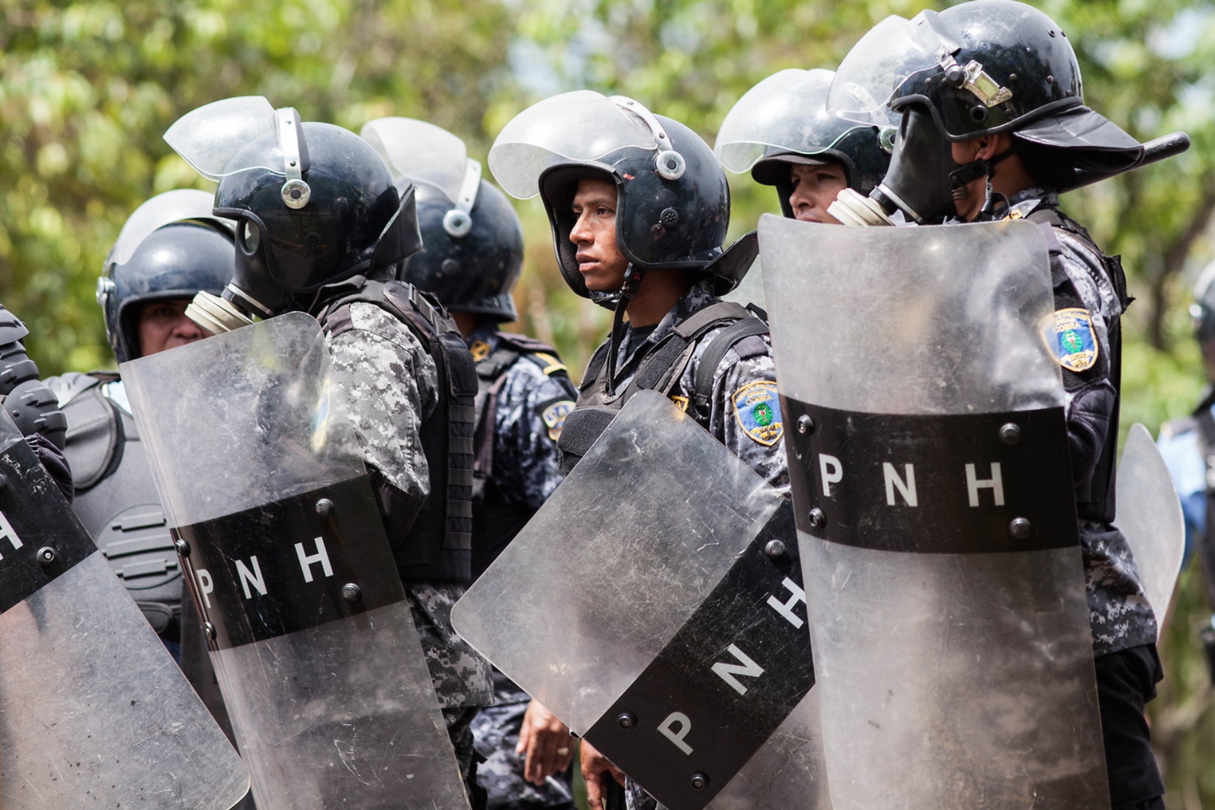RIot Police await orders to move forward into the UNAH University and begin firing tear gas cannisters into the crowds of protesting students. 10th August 2017.