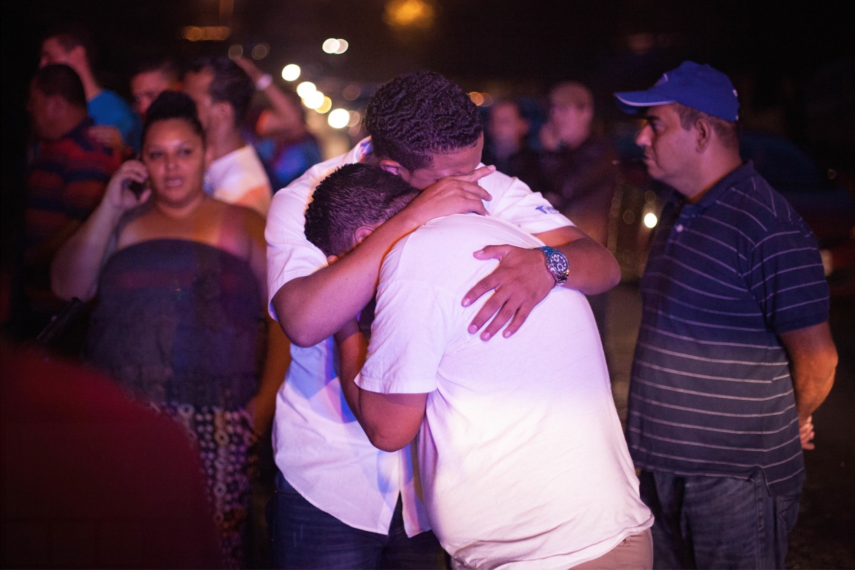 The two sons of a murdered taxi driver weep in the street at the sight of their father's motionless body. 8th August 2017.