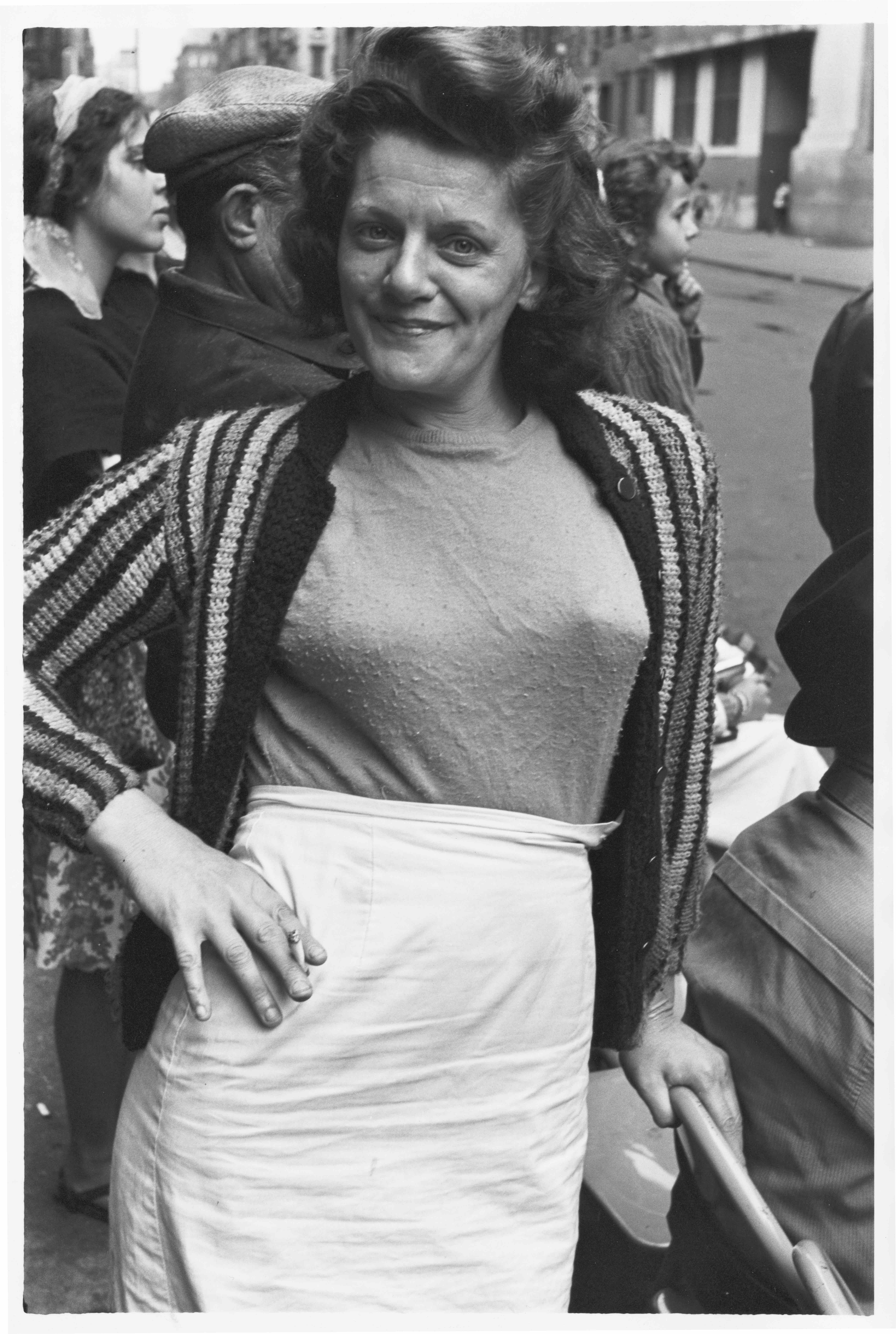 Woman with her hand on her hip, holding a cigarette, 1963