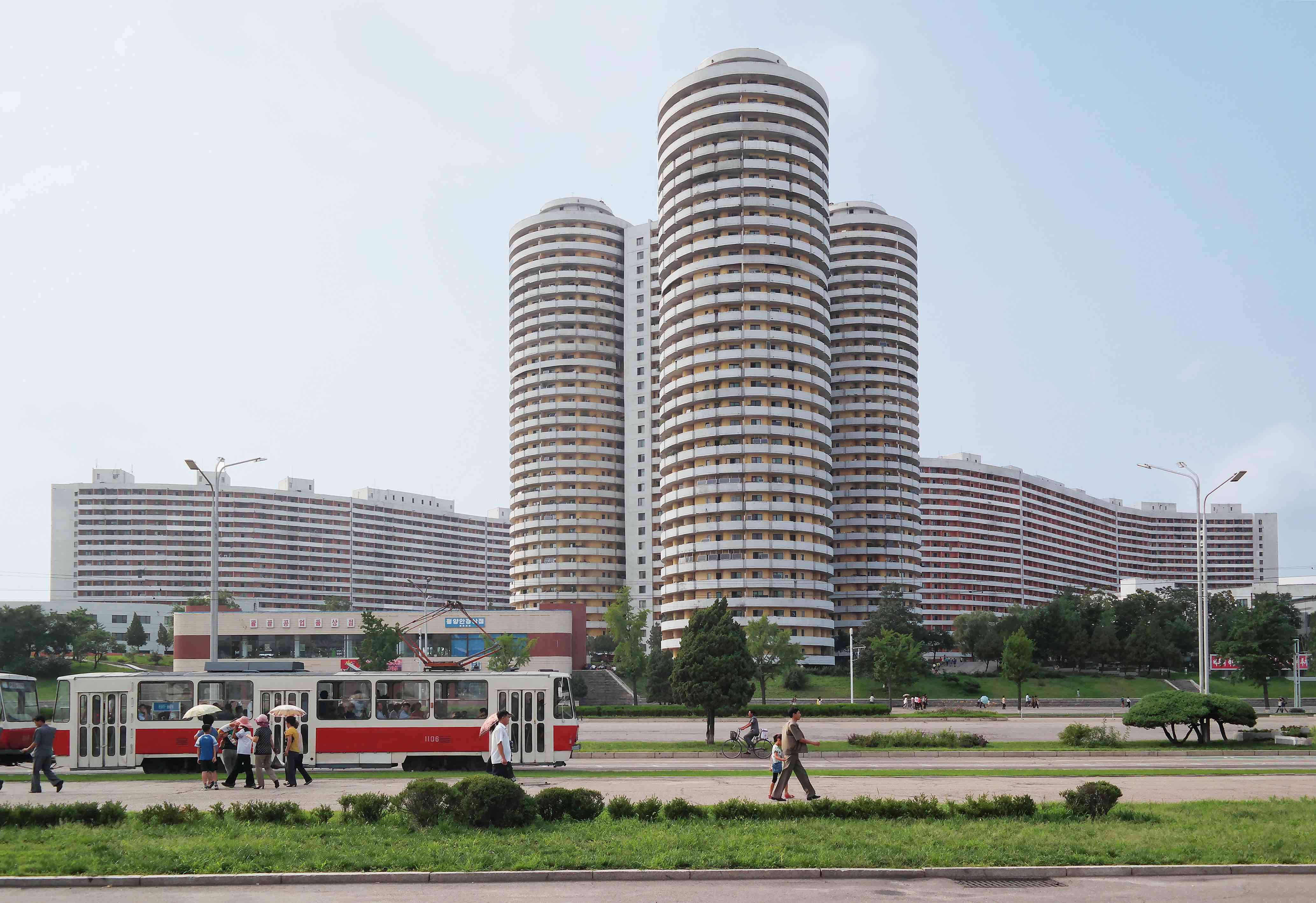 Cylindrical apartment towers for the Pyongyang elite line down the 4km- long avenue of Kwangbok Street, a ceremonial boulevard built for the 1989 World Festival of Youth and Students. As Kim Jong Il wrote approvingly: “In the formation of Kwangbok Street, a large variety of shapes, such as cylinders, windmills, polygons, the letter S and steps, were adopted for apartment blocks. [...] The arrangement of buildings on straight lines along the main street is an outmoded method.”